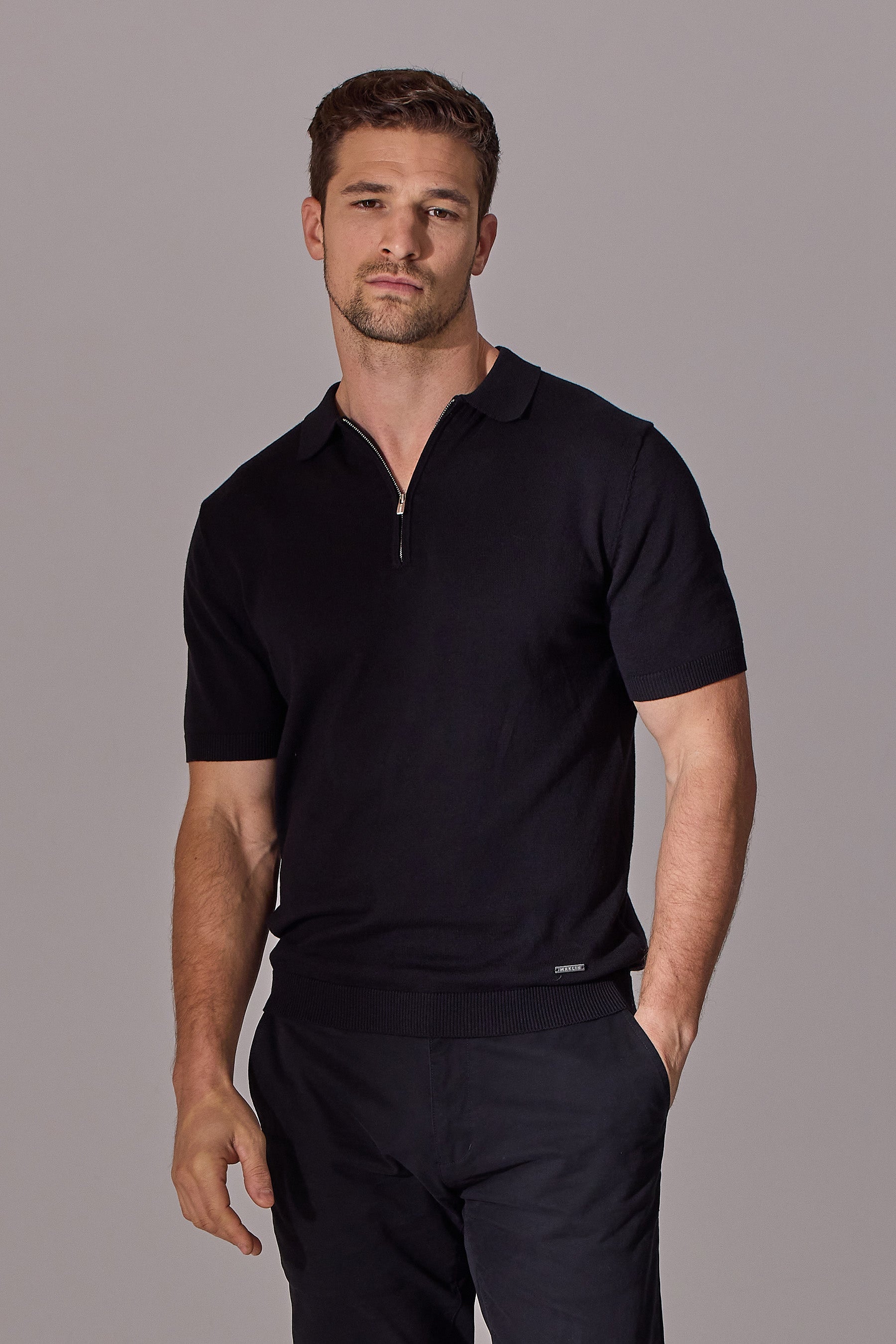 Black short sleeve polo shirt for men. Zip collar. Maklin Clothing.