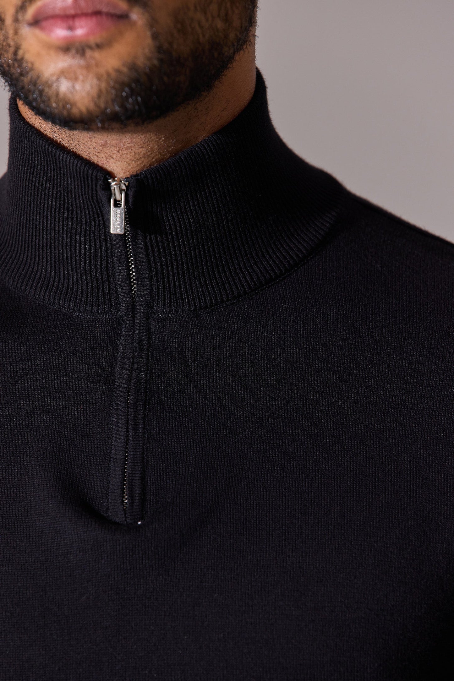 Close up-black long sleeve with zip collar polo shirt for men. Maklin Clothing.