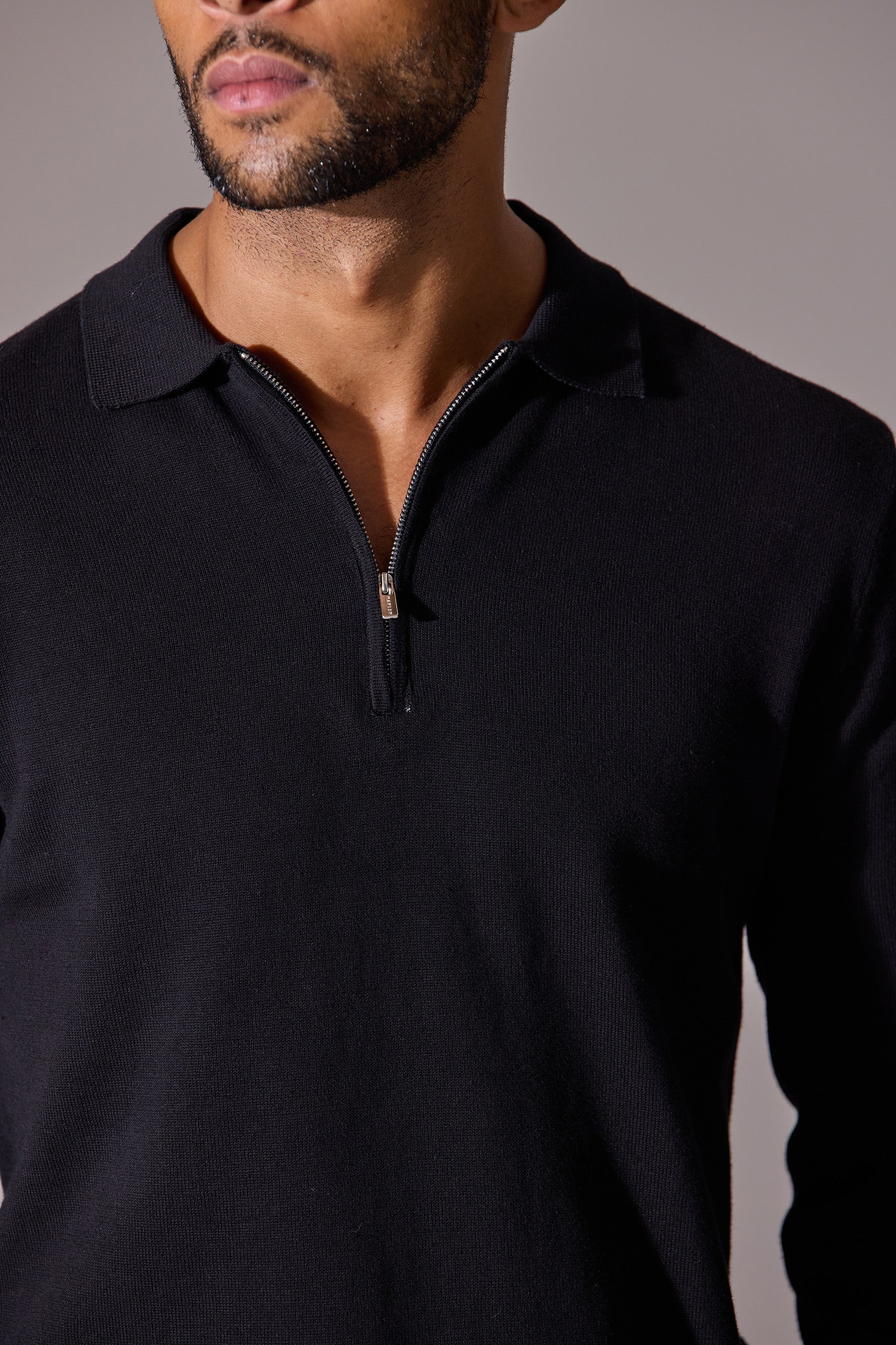 Black polo shirt for men. Featuring zip collar, long sleeves. Maklin Clothing, menswear